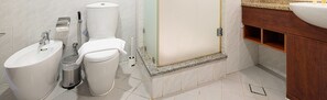 A bathroom with a toilet, bidet, sink, and trash can. - HomesGetaway- 1BR in JLT Lake Views (Dubai)