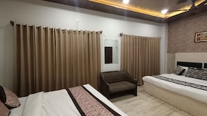 Una habitación de hotel con una cama, una silla y cortinas.
