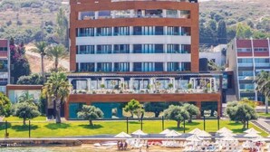 A modern hotel with multiple floors, a pool area, and beachside views. - Miramar Hotel Resort & Spa (Qalamoun)