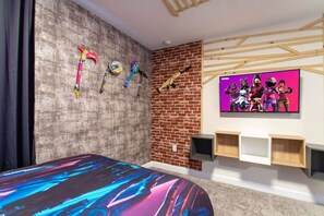 A bedroom with a bed, a brick wall, a mounted TV, and a wooden ceiling structure. - South Facing Pool! Private Game Room+Near Disney (Kissimmee)