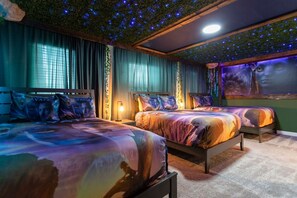 A bedroom with two beds, a ceiling with a starry design, and a wall mural. - South Facing Pool! Private Game Room+Near Disney (Kissimmee)