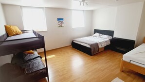 A room with a bunk bed, a single bed, and a desk. There are two windows providing natural light. - Duplex Close to the Casino de Namur (Namur)