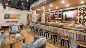 A bar area with stools, a pool table, and a cozy seating area with a couch and armchairs. - On Toccoa River - Luxury Riverfront - Hot tub (Mineral Bluff)