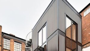 A modern building with large windows and a prominent corner design.
