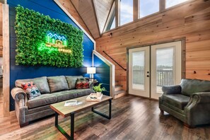 Relax in a cozy space with a comfortable sofa, wooden coffee table, and large window with blinds.