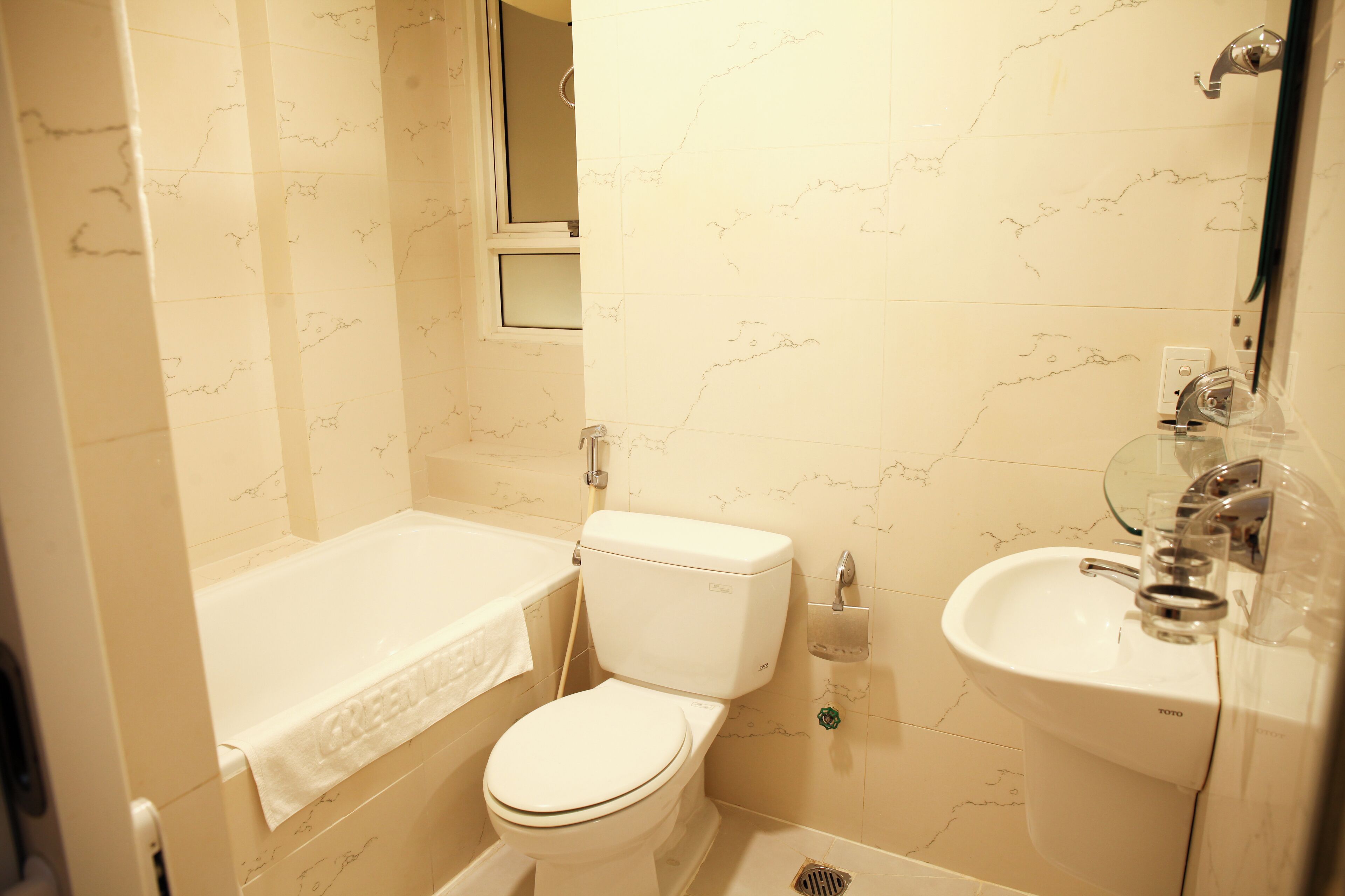 A bathroom with a toilet, bathtub, and sink.