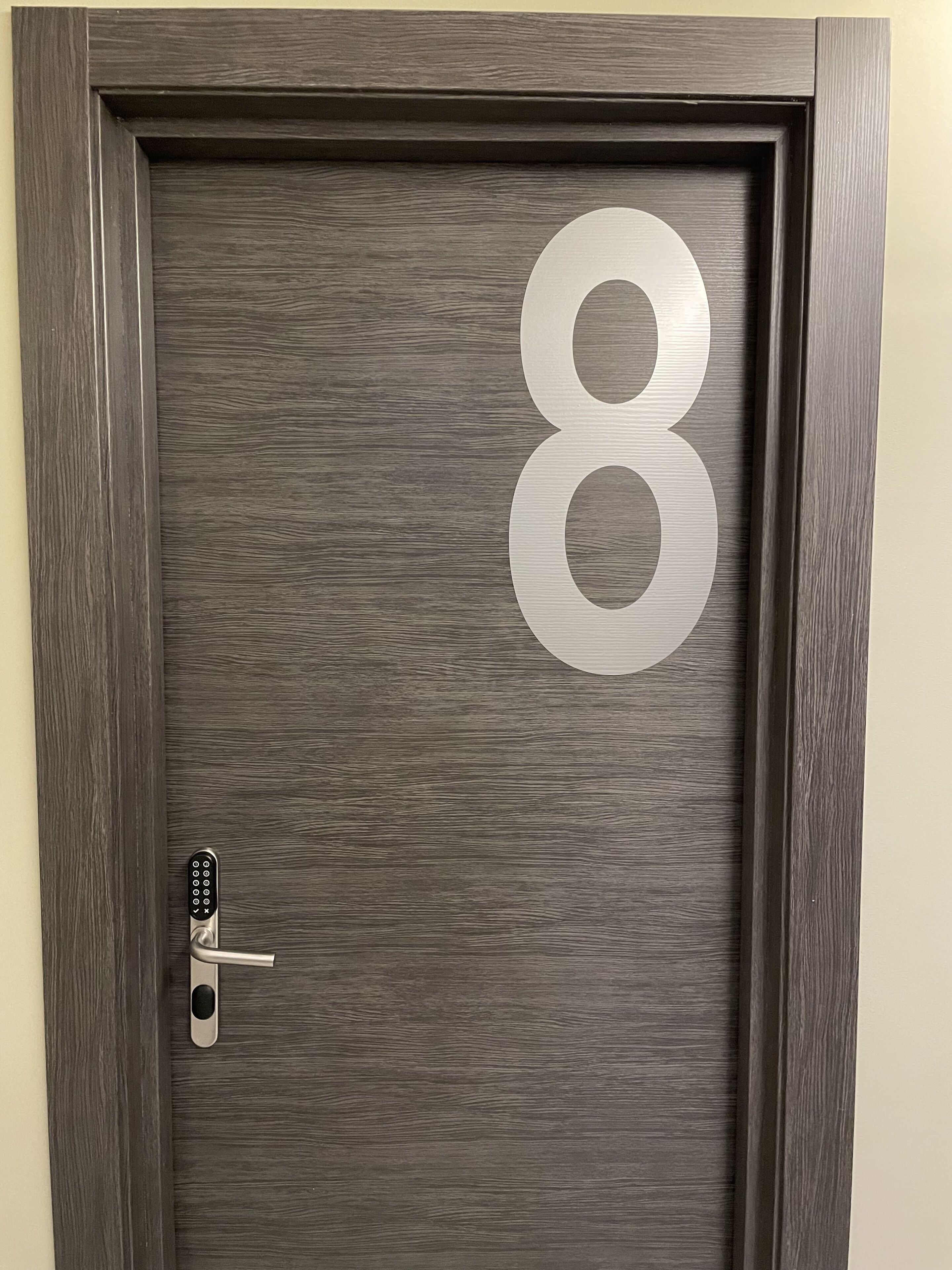 Una puerta con el número 8 grande y una cerradura.