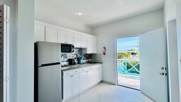 Full-size fridge, microwave, coffee/tea maker, cookware/dishes/utensils