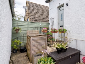 Enjoy a peaceful retreat in this serene garden area, surrounded by lush greenery and a seating area.