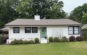 A single-story house with a green door, white exterior, and a small front porch. - 3 Bed, 1 Bath Adorable Home – Less than 10 minutes from Bryant-Denny Stadium! (Northport)