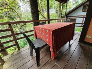 Enjoy a tranquil outdoor space with a table for two, surrounded by a lush forest.