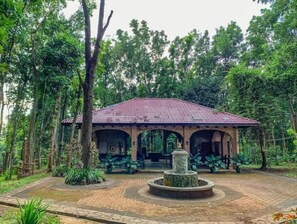 Experience tranquility in this traditional-style building with an open front, central fountain, and lush surroundings.