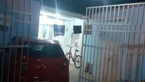 A gated parking area with a red car parked inside. - Alugo Casa NA Praia Grande Próximo AO Centro DE Mongaguá Acomoda ATE 15 Pessoas (Cidade das Crianças Praia Grande)