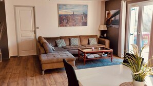 A living room with a sofa, a coffee table, and a door.