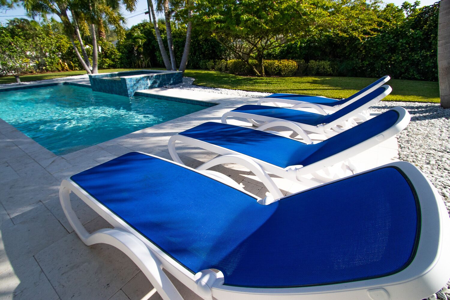 A poolside area with lounge chairs and a swimming pool.