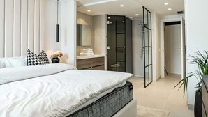 A modern bedroom with a large bed, a walk-in closet, and a glass shower enclosure. - Penthouse with sea views in San Pedro de Alcántara by Costarentals - Ref M34 (San Pedro Alcántara)