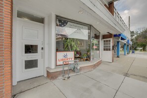 Liberty Tax Service office features a white facade with a brick base and a prominent sign displaying the business name and services offered.