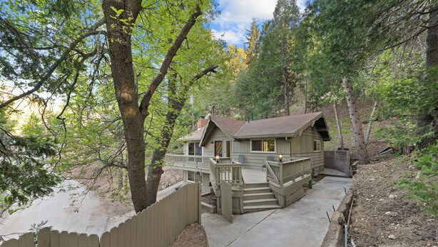 A cabin with a deck, surrounded by trees. - Crestline Lake Gregory Cabin  (Crestline)