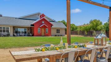 Enjoy al fresco dining in a charming outdoor setting with a table for four, surrounded by comfortable seating.