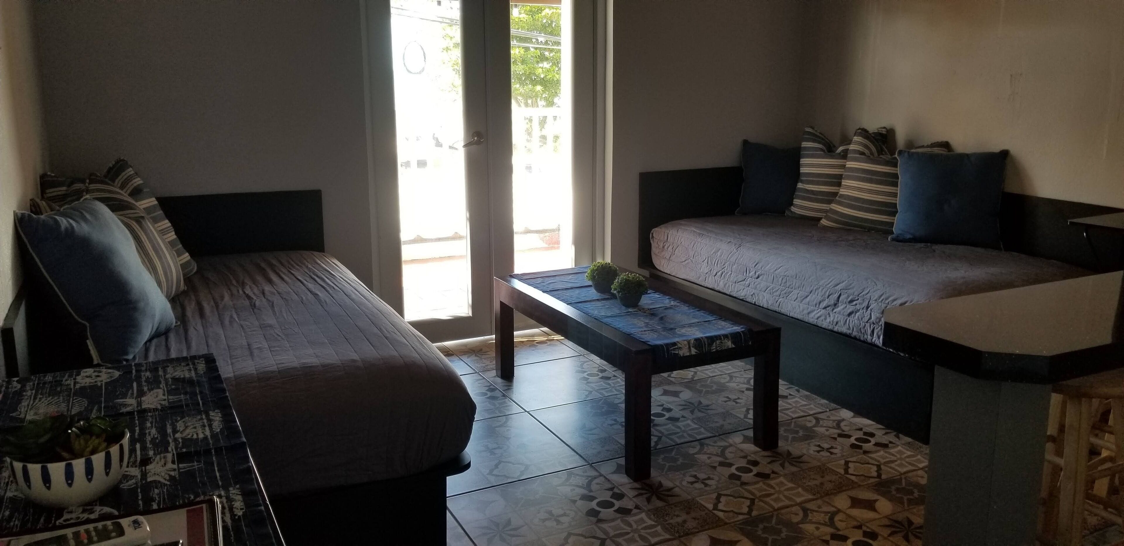 A compact living space with a sofa, a small table, and a bench.