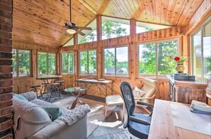A wooden cabin with a dining area, a sofa, and a table. - Celebrate Claire de Lune Mountain Lake Home (Hayesville)
