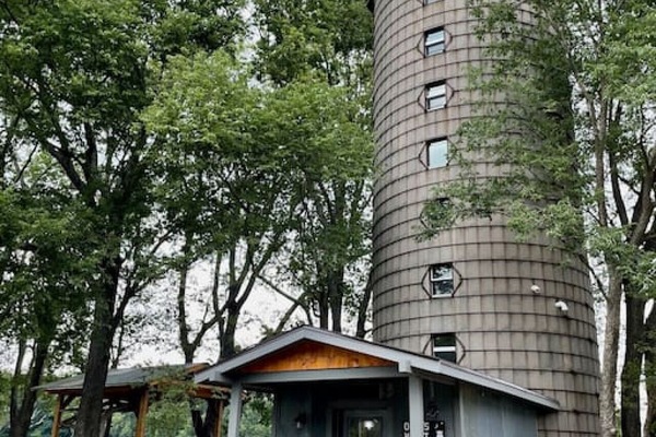 Front view of silo with parking to the right and outdoor patio to the left