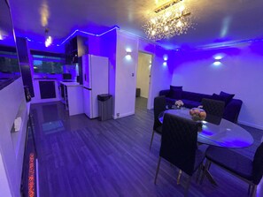A modern apartment with a kitchen, dining area, and living room. - Chic 2 Bedroom Flat (Trimley Saint Mary)