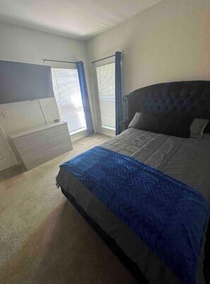 Relax in a spacious room with a large bed, wardrobe, and flat-screen TV.