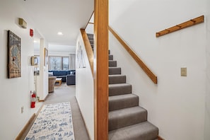 Staircase Leading to Upper Level - Carpeted staircase providing access to additional living or sleeping space.