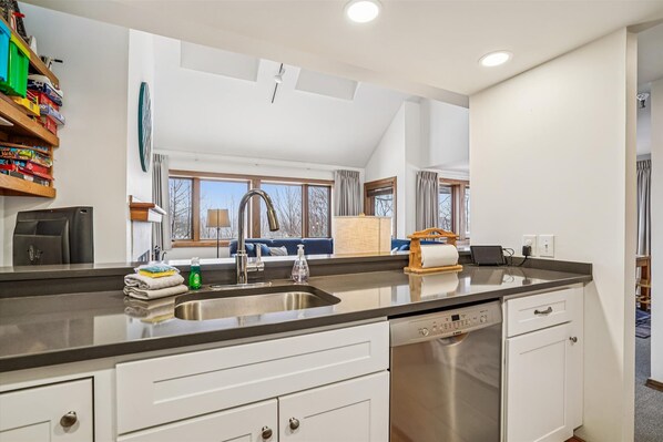 Kitchen with Breakfast Bar & Open Sightlines - Enjoy cooking while staying connected to the living area through the open pass-through design.