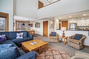 Spacious Open-Concept Gathering Area - Comfortable seating flows seamlessly into the kitchen and dining area, making it perfect for relaxing or spending time together.