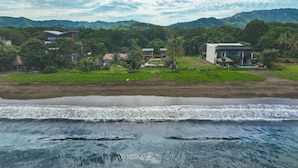 A coastal resort with beachfront properties, a sandy beach, and lush greenery. - Beachfront Villa Elysian Sol Suite Sleeps 3 (Provincia de Guanacaste)