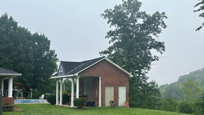 A single-story brick house with a covered porch and a front door. - Large private room in a large home nestled in the mountain of Johnson county Ky. (Hagerhill)