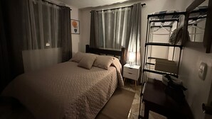 A bedroom with a bed, a nightstand, a lamp, a mirror, and a bunk bed. - Villas Winara With Private Pool and Close to Amazing Waterfalls (Curubandé)
