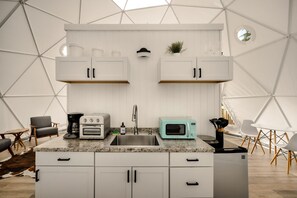 Fridge, microwave, coffee/tea maker, cookware/dishes/utensils