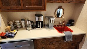 A kitchen with a coffee maker, a toaster, a sink, and a dish rack. - Blue Room at the Feitshans House (Springfield)