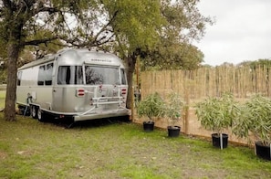 Airybeam trailer features an outdoor space with potted plants and a wooden fence.