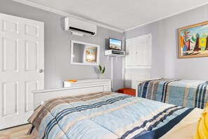 A bedroom with two beds, a dresser, a TV, and a painting. - Mariners Cove w/ Water Views, Near Beach, 3 Beds (Myrtle Beach)