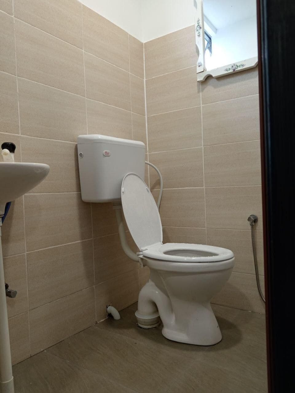 A bathroom with a toilet, sink, and shower.