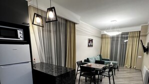 Deluxe Apartment | Living area | 50-inch Smart TV with cable channels - Uparthotel (Tsaghkadzor)