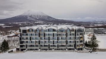 A modern multi-story hotel with a symmetrical facade, large windows, and a flat roof.