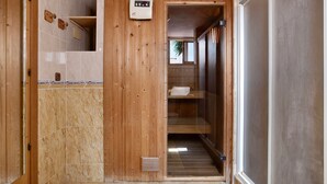 A wooden interior with a shower area, a control panel, and a glass door leading to a room. - Holiday Home 'Torremuelle' with Sea Views, Pool, Terrace and Garden (Benalmadena)