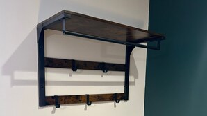 A wall-mounted shelf with three horizontal wooden planks and a metal frame. - OYO The Avenue (Scunthorpe)