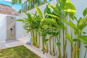outdoor space with a pathway leading to a secluded entrance.