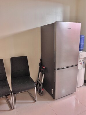 Enjoy a modern space with a compact kitchenette, refrigerator, and seating area.