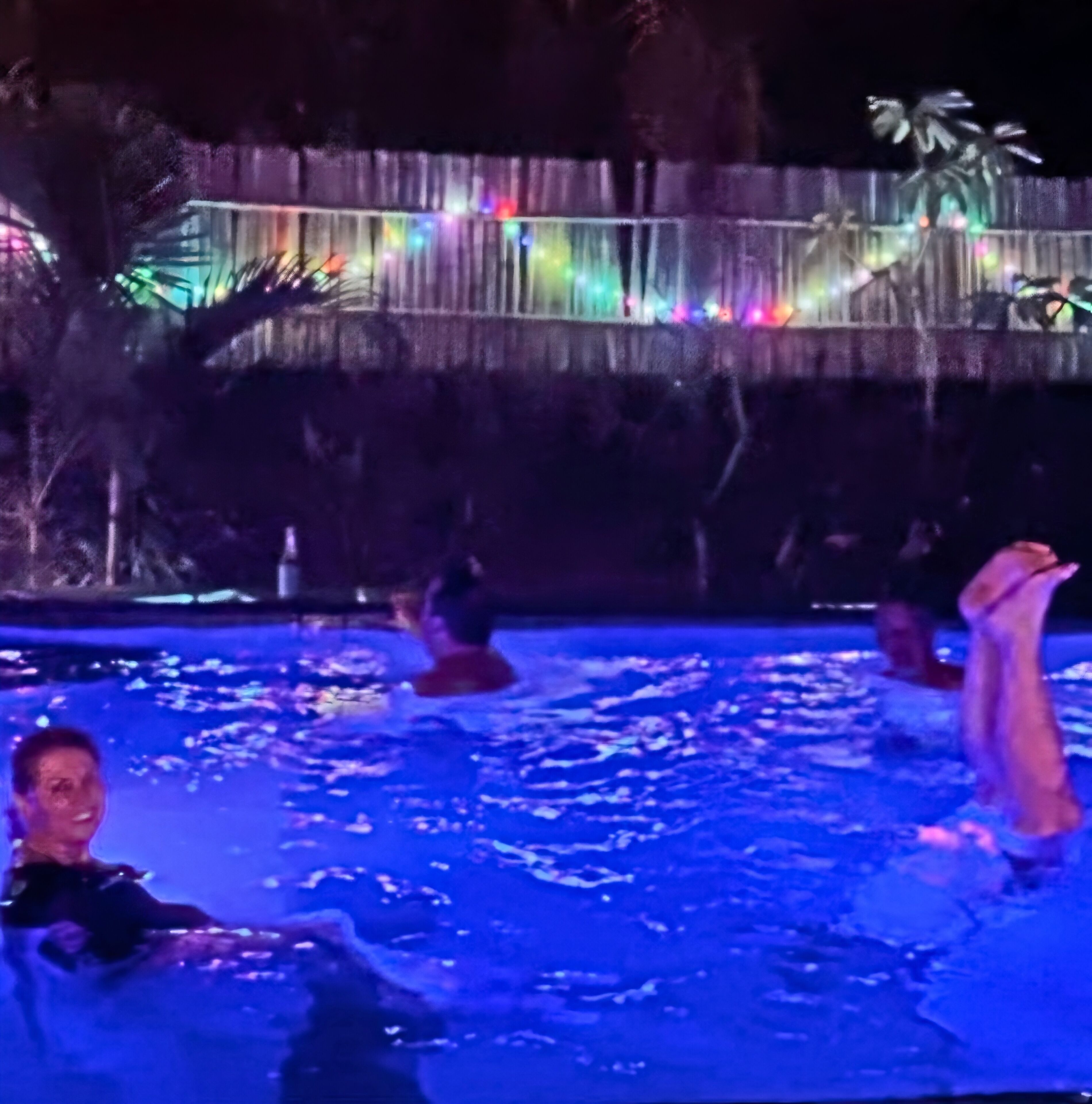 A swimming pool with people enjoying the water.