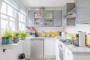 Kitchen features an oven, gas stove, and ample counter space for meal preparation.
