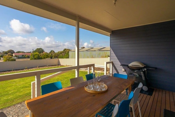 Back undercover patio facing fully fenced back yard with lawn/grassed area