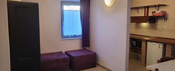 A compact kitchen with a window, a refrigerator, and a small dining area. - Guardea, Apartment, 20 minutes from Orvieto (Guardea)