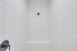 A bathroom with white tiled walls and a shower area. - North Padre Island Roomy Beach House Unit B (Corpus Christi)